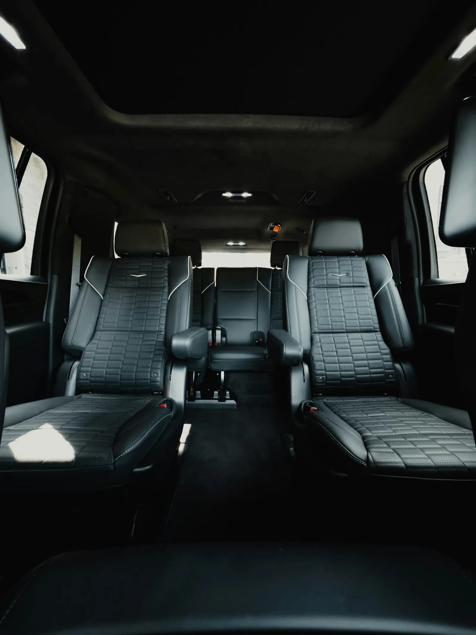 Second-row leather captain's chairs inside a Cadillac Escalade